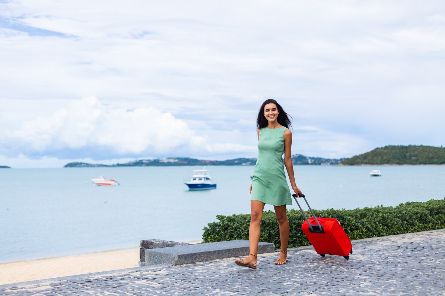 happy-caucasian-pretty-long-hair-elegant-tourist-woman-dress-with-red-suitcase-outside-hotel_343596-3638